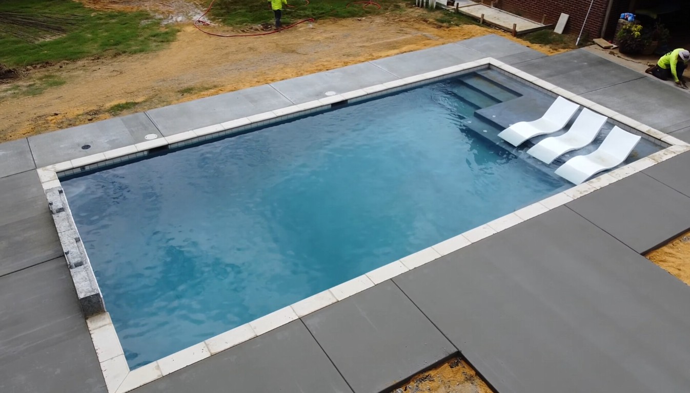 Professional concrete pool deck installation with slip-resistant finish in Woburn, MA